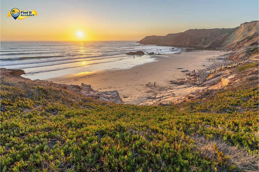 People walking on a beach at sunset in the Algarve Portugal